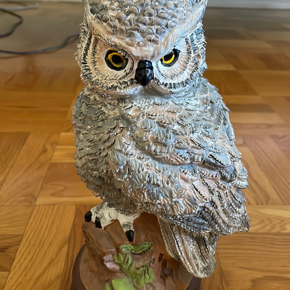 Ceramic Owl sitting in a piece of wood